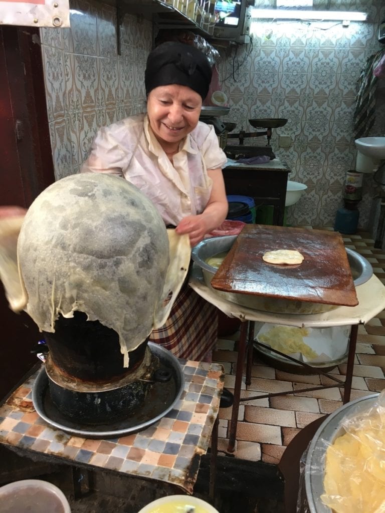 Street food vendor making Morocco pancakes