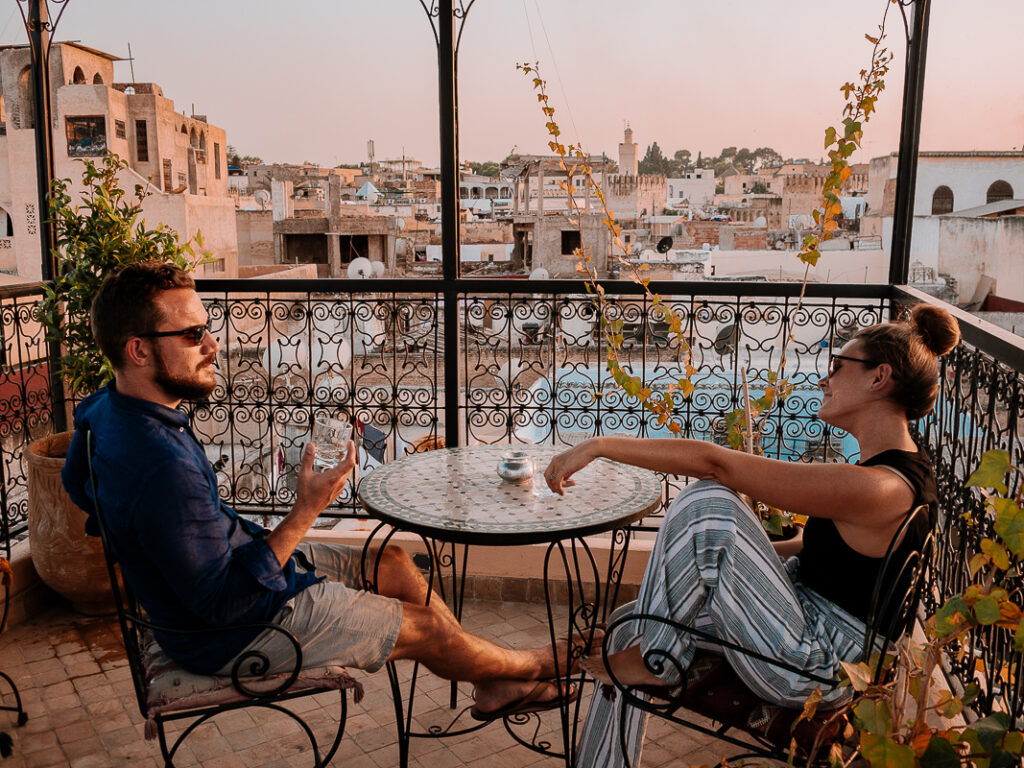 Couple enjoying sunset from a rooftop in Fes