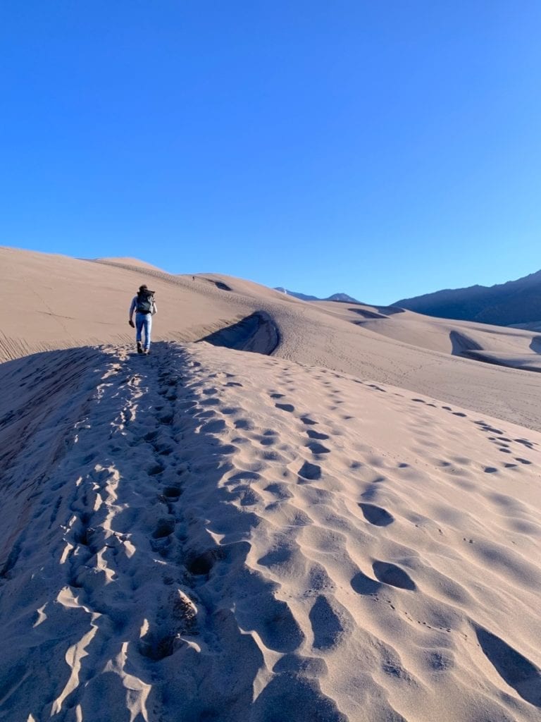 Jesse hiking up the sand dunes