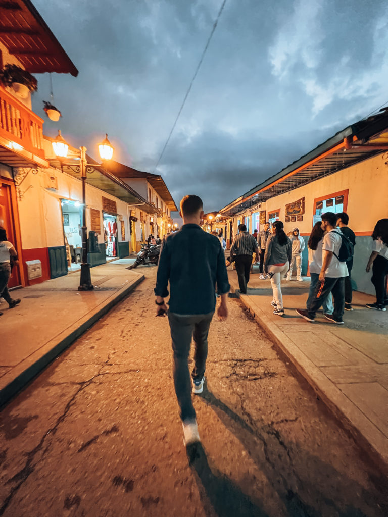 Jesse walking down Calle Real at dusk